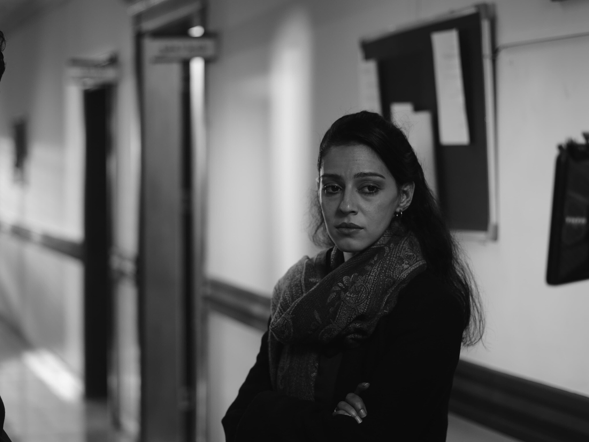 Black and white character portrait of Gheed in a hallway