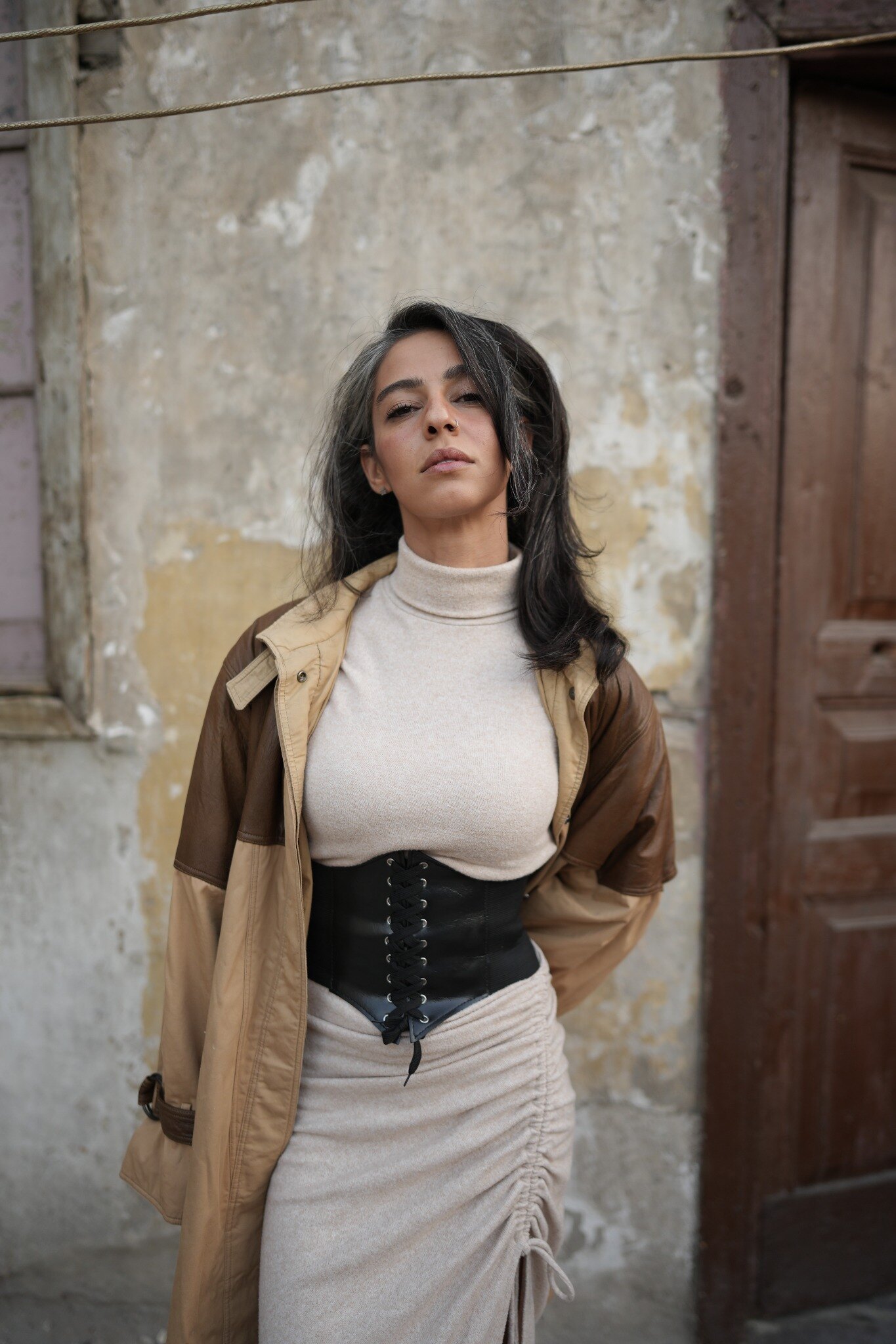 Gheed in an editorial portrait against a weathered wall