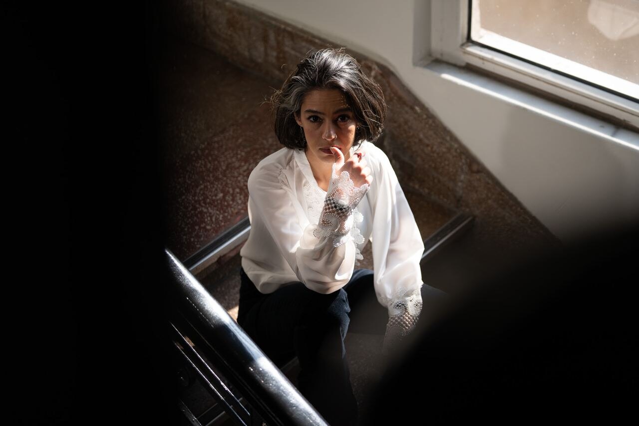 Gheed looking upward on a staircase in directional light